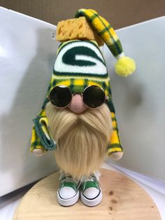 a stuffed animal wearing sunglasses and a green bay packers hat