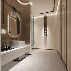 a bathroom with marble counter tops and white walls, along with a large mirror on the wall