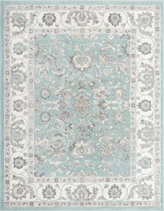 a blue and white rug with an ornate design on the bottom, in front of a light green background