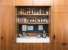 a wooden cabinet filled with lots of bottles