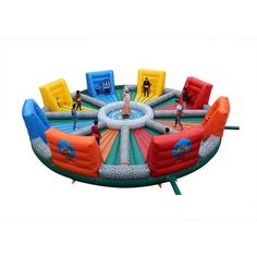 an inflatable game with people playing on the top and one person standing at the center