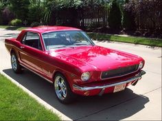 a red car parked in front of a house