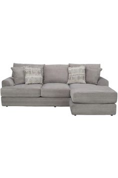 a gray sectional couch with pillows on the top and bottom corner, in front of a white background