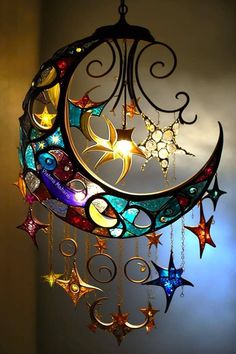 a multicolored moon and stars wind chime hanging from the ceiling