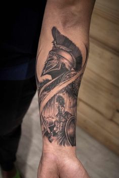 a man's arm with a tattoo on it and an eagle in the middle