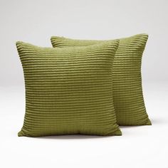 two green pillows sitting next to each other