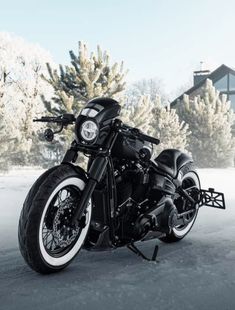 a black motorcycle is parked in the snow