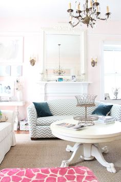 a living room filled with furniture and a chandelier