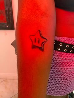 a person with a red tattoo on their arm