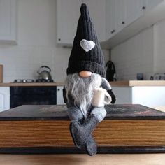 an old fashioned gnome sitting on top of a book