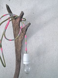 a light bulb hanging from a tree branch with the words 10 new ways to use wash tape