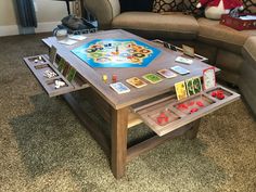 a living room filled with furniture and a game on top of a wooden coffee table