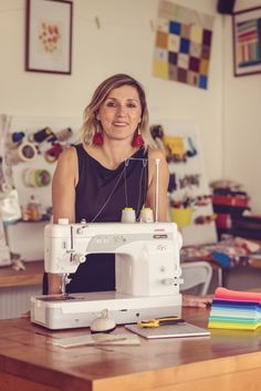 a woman sitting in front of a sewing machine