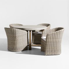 an outdoor table with four chairs and a round dining table in wicker weaves