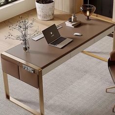 a laptop computer sitting on top of a wooden desk in front of a large window