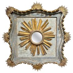 a mirror that is sitting on top of a tray with sunbursts in it