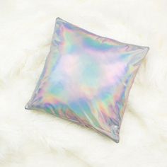 a holographic pillow on a fluffy white surface