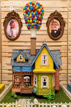 a toy house with balloons and pictures on the wall