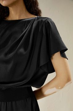 Step into the realm of fashion, where comfort intertwines with elegance. Meticulously designed with an exquisite boatneck, rippled batwing sleeves, elastic rib on the bottom, and crafted seams, this top speaks volumes in any setting. Short rippled batwing sleeves Boatneck Elastic rib on bottom Easy to wear Meticulously crafted seams Fall Ribbed Cuffs Batwing Sleeve Tops, Black Batwing Sleeve Tops For Loungewear, Black Satin Boat Neck Shirt, Black Silk Short Sleeve Top, Black Silk Top With Button Closure, Nordstrom Store, Batwing Sleeve, Silk Shirt, Boat Neck