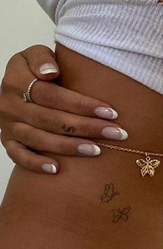 a woman's stomach with tattoos on her belly and the word love written in gold