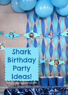 a shark birthday party with blue balloons and decorations