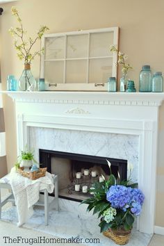 a living room filled with furniture and a fire place covered in vases on top of a mantle