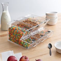 three plastic containers filled with cereal and apples