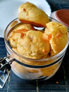 some muffins in a glass bowl on a table