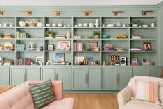 a living room filled with lots of furniture and bookshelves covered in green paint