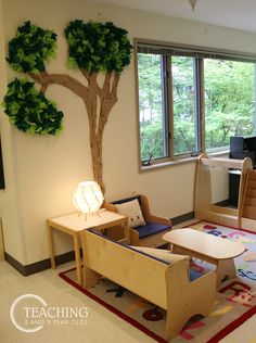 a living room filled with furniture and a tree in the middle of it's wall