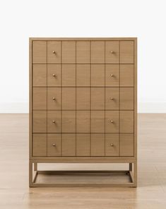 a wooden dresser with many drawers on it's sides and one drawer in the middle