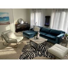 a living room with zebra print rugs and blue couches