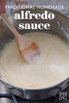 the best homemade alfredo sauce is in a pot with a wooden spoon on the stove