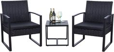 two chairs and a table with wine glasses on it, one chair has a side table