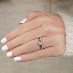 a woman's hand wearing a diamond ring