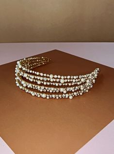 One of our layered, 3D headbands filled with crystals and pearls, RAINA Swarovski headband. The 3D design mixed with pearls will elevate any hairstyle. It is a gorgeous pick for a timeless and elegant look. Handcrafted Highest Quality Swarovski / Cubic Zirconia / Pearls Platinum plated Guards against scratches and tarnish. approximate size 1" tall Free Shipping in USA Bridal Headbands, Rose Gold Tiara, Bridal Hair Combs Pearl, Elegant Headband, Bridal Tiaras, 2024 Ideas, Pearl Headpiece, Crown Earrings, Gold Headpiece