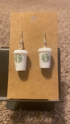 starbucks cup earrings are on display in a cardboard box