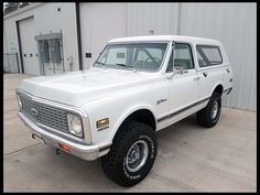 a white truck parked in front of a building