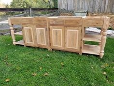 a wooden cabinet sitting in the grass