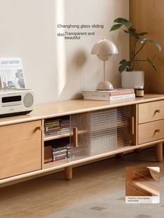 an entertainment center with books, magazines and a radio on it's sideboard