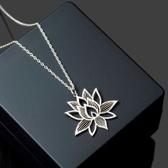 Elevate your style with the exquisite Lotus Flower Necklace from Sussex Home, a symbol of purity and grace. This sterling silver pendant is meticulously handcrafted in our workshop, ensuring each piece is a unique testament to artisan skill.

- Material: Sterling Silver
- Color: Silver
- Gender: Female
- Age Group: Adult

Ideal for bridesmaids, friends, or as a cherished gift to yourself, this necklace represents elegance and sophistication. To maintain its luster, avoid exposure to heat and har Nature-inspired Flower Shape Necklace As A Gift, Nature-inspired Flower Shaped Necklace For Gift, Nature-inspired Flower Shaped Necklace Gift, Spiritual Sterling Silver Flower Shaped Jewelry, Spiritual Flower Pendant Jewelry For Mom, Spiritual Sterling Silver Flower Jewelry, Spiritual Flower Pendant Jewelry Gift For Mom, Elegant Handmade Flower Charm Necklaces, Elegant Silver Birth Flower Charm Necklace