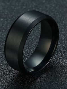 a black wedding ring on a dark surface