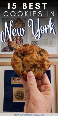 a person holding up a cookie in front of a framed photo with the words 15 best cookies in new york