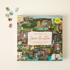 the world of jane auster book on a white surface with puzzle pieces surrounding it