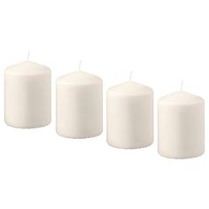 four white candles sitting side by side