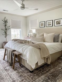 a large bed sitting on top of a rug in a bedroom next to a window