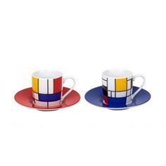 two cups and saucers with colorful designs on them