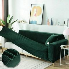 a woman standing next to a green couch in a living room