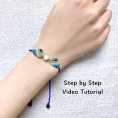 a woman's hand with a bracelet made out of glass beads and bead