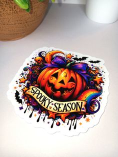 a sticker that says spooky season with a halloween pumpkin on the front